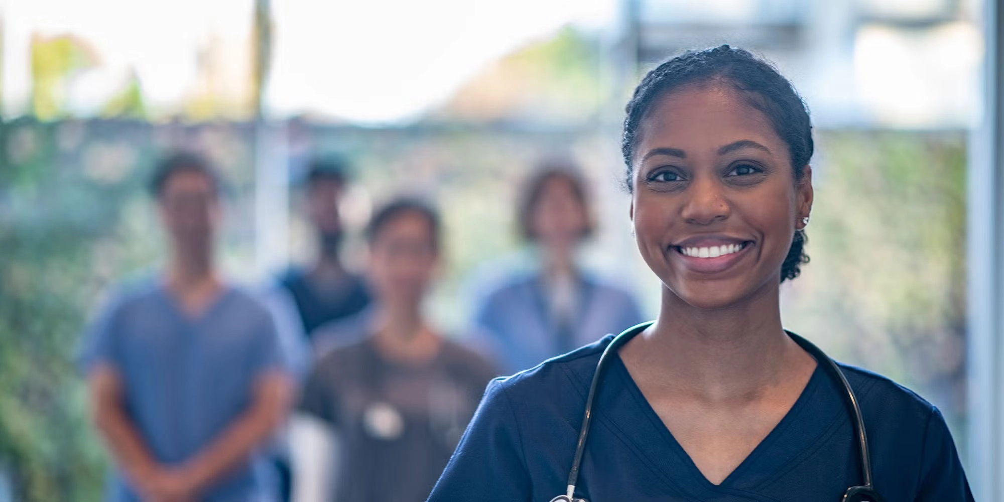 A group of medical residents gathers in a hospital hallway