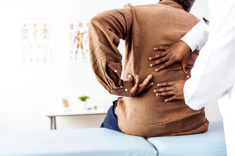 woman and doctor examining back